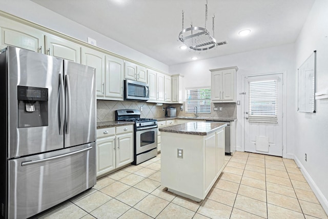 2725 Albatross Ln, Fort Worth, TX 76177 - kitchen featuring stainless steel appliances, backsplash, light tile patterned floors, a center island, and recessed lighting