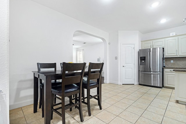 2725 Albatross Ln, Fort Worth, TX 76177 - dining space featuring arched walkways, light tile patterned flooring, and recessed lighting