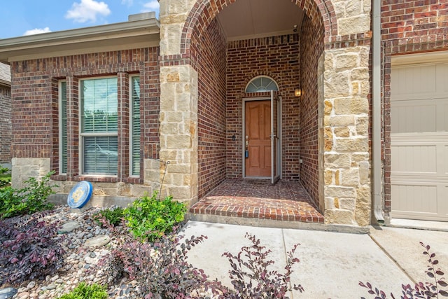 2725 Albatross Ln, Fort Worth, TX 76177 - view of exterior entry featuring brick siding, a garage, and stone siding