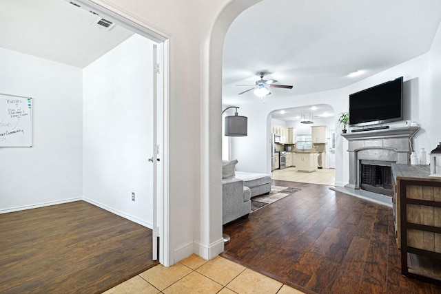 2725 Albatross Ln, Fort Worth, TX 76177 - living room with arched walkways, ceiling fan, and light wood-type flooring