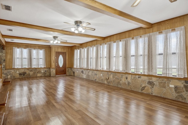 interior space featuring wood finished floors, a healthy amount of sunlight, visible vents, and ceiling fan