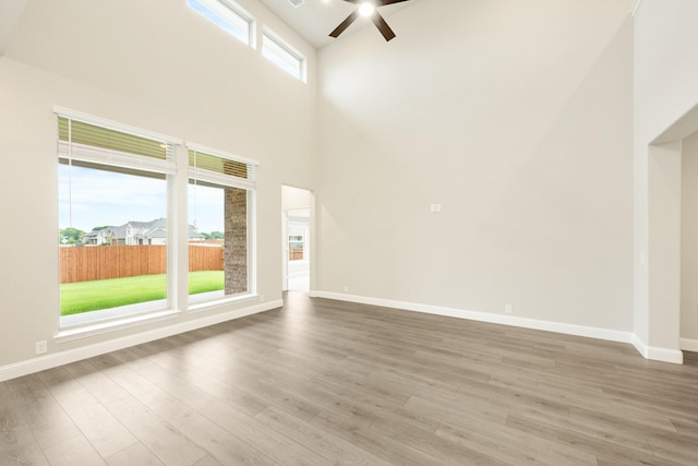 4400 Copper Point Dr, Fort Worth, TX 76036 - unfurnished living room with ceiling fan, a high ceiling, and wood finished floors
