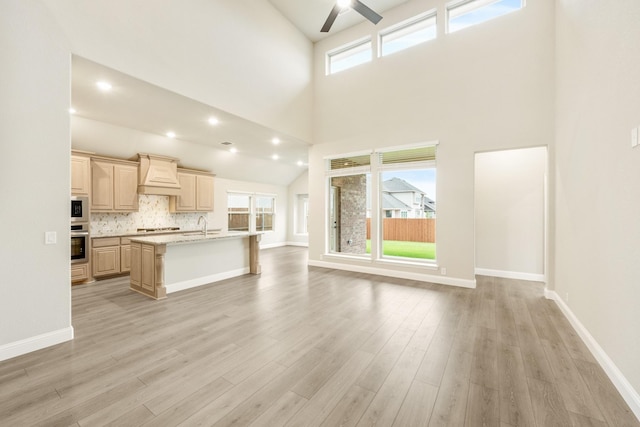 4400 Copper Point Dr, Fort Worth, TX 76036 - unfurnished living room featuring a ceiling fan, high vaulted ceiling, healthy amount of natural light, and light wood-style floors