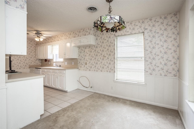 kitchen with wainscoting and wallpapered walls