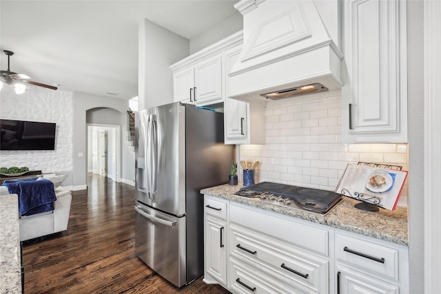9413 Lakeway Dr, Denton, TX 76226 - kitchen featuring custom range hood, stainless steel appliances, arched walkways, and dark wood-type flooring