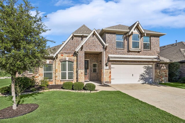 view of front of property featuring an attached garage, a front lawn, stone siding, brick siding, and concrete driveway