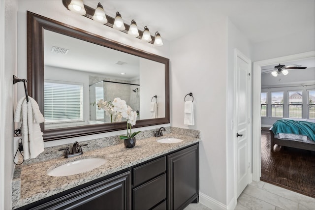 9413 Lakeway Dr, Denton, TX 76226 - full bath with ensuite bathroom, a shower stall, double vanity, and healthy amount of natural light