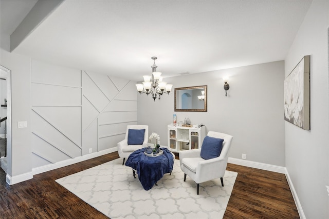 living area featuring baseboards, visible vents, dark wood finished floors, and a chandelier