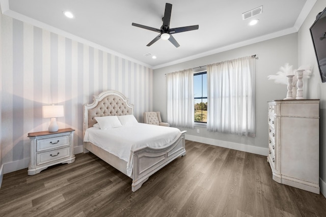 bedroom featuring visible vents, wallpapered walls, baseboards, ornamental molding, and wood finished floors