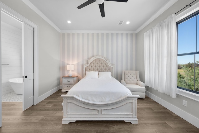 bedroom featuring ornamental molding, wallpapered walls, baseboards, and wood finished floors