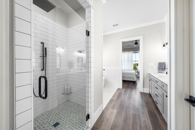 ensuite bathroom featuring wood finished floors, visible vents, a shower stall, crown molding, and connected bathroom