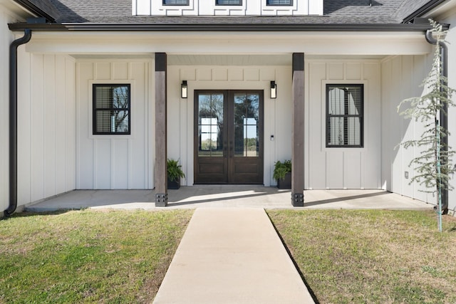 entrance to property featuring french doors, board and batten siding, and a shingled roof