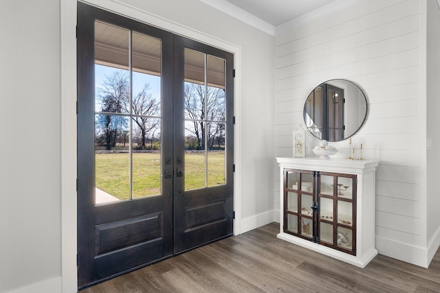 foyer entrance with dark wood finished floors, french doors, baseboards, and a wealth of natural light