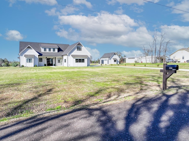 view of front of property featuring a front lawn and board and batten siding