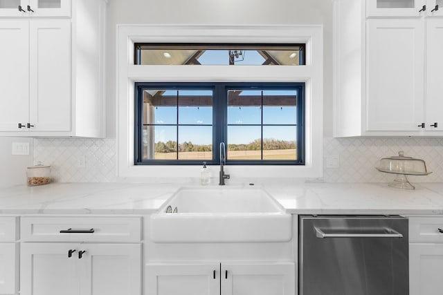 kitchen featuring white cabinetry, stainless steel dishwasher, glass insert cabinets, and a sink