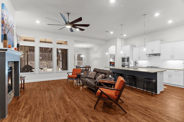 3509 Concord Dr, Melissa, TX 75454 - living area featuring a ceiling fan, dark wood-style flooring, recessed lighting, and a stone fireplace