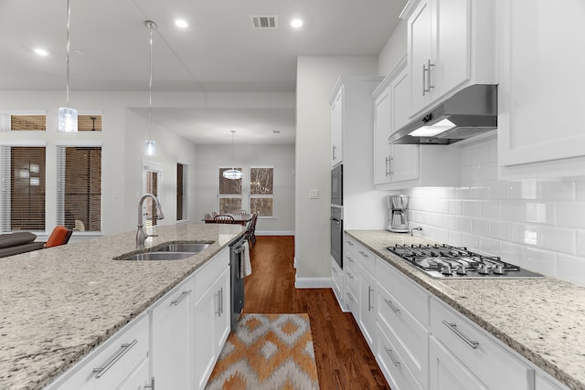 3509 Concord Dr, Melissa, TX 75454 - kitchen featuring under cabinet range hood, a sink, appliances with stainless steel finishes, dark wood-style flooring, and baseboards
