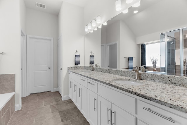 3509 Concord Dr, Melissa, TX 75454 - bathroom with double vanity, baseboards, vaulted ceiling, a bath, and an enclosed shower