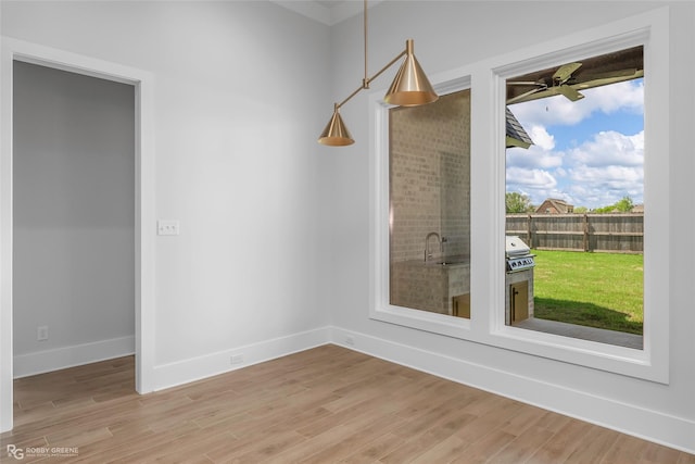 interior space featuring baseboards and light wood-type flooring