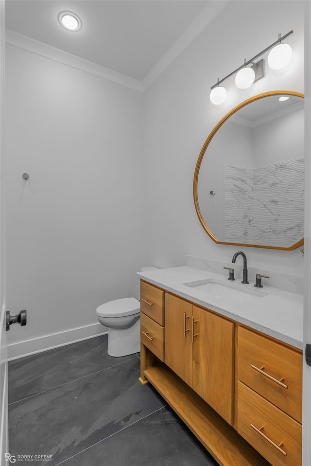 bathroom featuring toilet, vanity, baseboards, and ornamental molding
