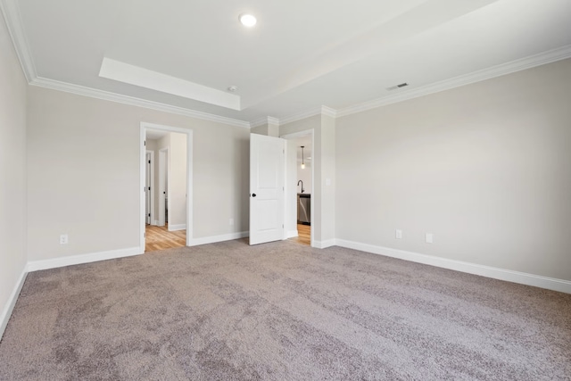 214 Briarwood Dr, Nevada, TX 75173 - unfurnished bedroom with baseboards, visible vents, ornamental molding, light carpet, and a raised ceiling