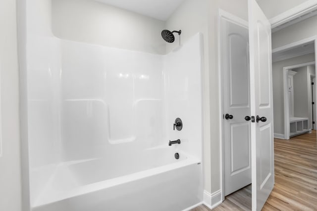 214 Briarwood Dr, Nevada, TX 75173 - bathroom featuring tub / shower combination, baseboards, and wood finished floors