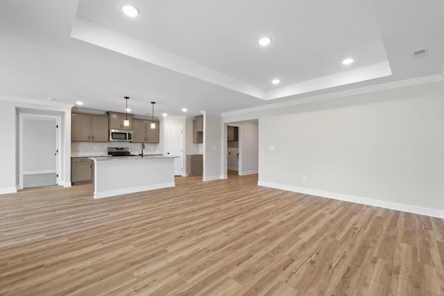 214 Briarwood Dr, Nevada, TX 75173 - unfurnished living room featuring light wood-style flooring, crown molding, and a tray ceiling