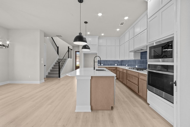 2012 Tolleson Dr, Fort Worth, TX 76008 - kitchen featuring appliances with stainless steel finishes, decorative backsplash, light wood-style floors, recessed lighting, and white cabinetry