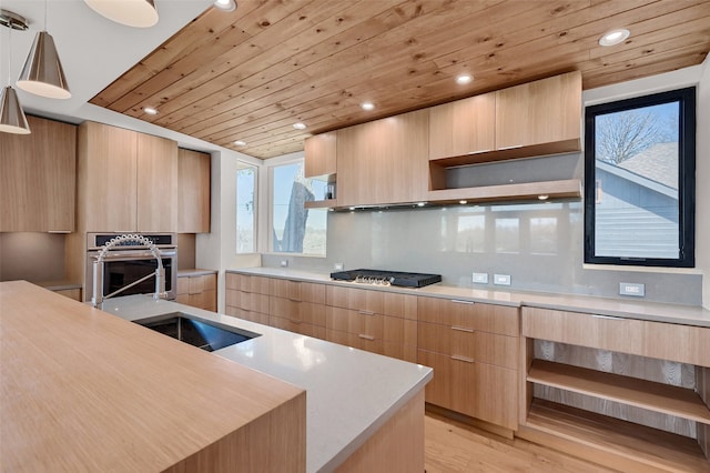 kitchen with light brown cabinetry, appliances with stainless steel finishes, modern cabinets, and open shelves