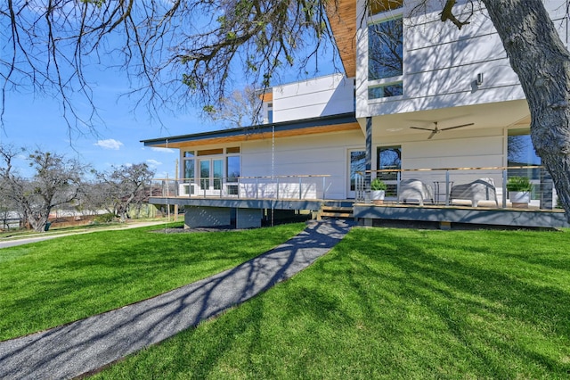 exterior space featuring a deck and a lawn