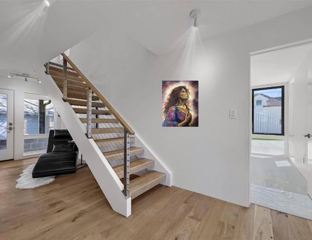 staircase with wood finished floors