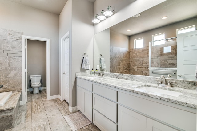6565 Oak Point Cir, Royse City, TX 75189 - bathroom featuring double vanity, a bath, toilet, and baseboards