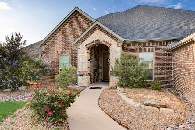 6565 Oak Point Cir, Royse City, TX 75189 - entrance to property featuring a shingled roof, brick siding, and stone siding