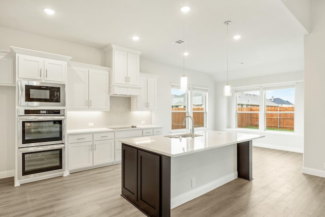 817 Lakewood Ct, Midlothian, TX 76065 - kitchen with a sink, built in microwave, backsplash, light wood-style flooring, and recessed lighting