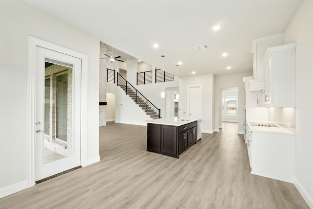 817 Lakewood Ct, Midlothian, TX 76065 - kitchen featuring light countertops, a sink, light wood-style floors, an island with sink, and recessed lighting