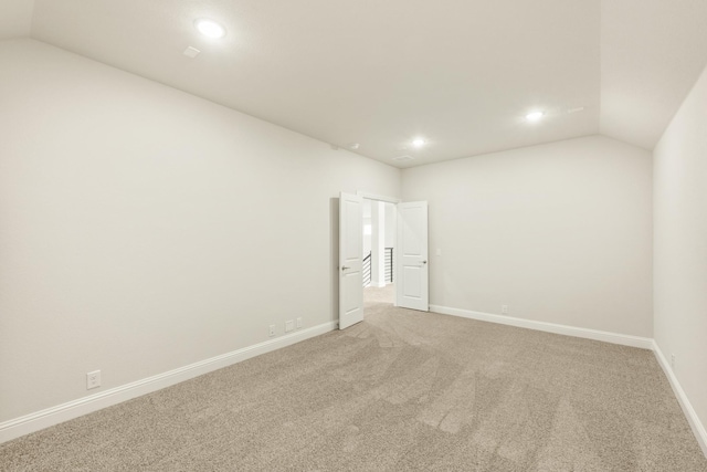 817 Lakewood Ct, Midlothian, TX 76065 - spare room with vaulted ceiling, recessed lighting, light colored carpet, and baseboards