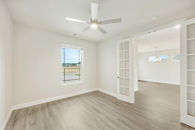 817 Lakewood Ct, Midlothian, TX 76065 - spare room with french doors, wood finished floors, a chandelier, and healthy amount of natural light
