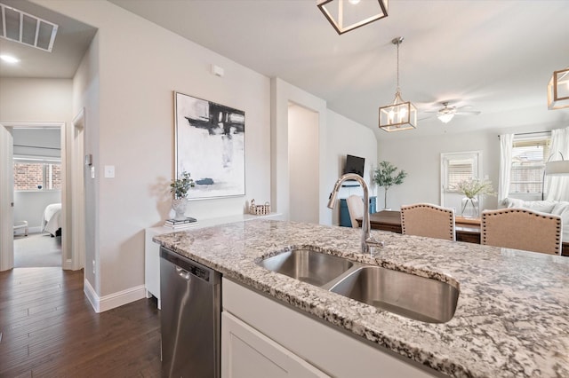 kitchen with a sink, baseboards, open floor plan, stainless steel dishwasher, and visible vents