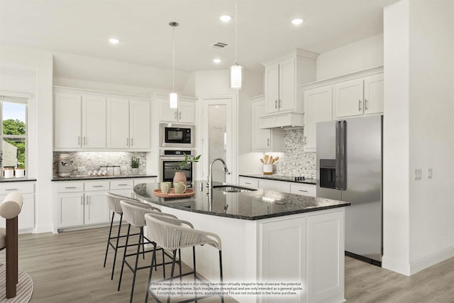 4217 Bel Air Dr, Midlothian, TX 76065 - kitchen with appliances with stainless steel finishes, a sink, decorative backsplash, light wood-type flooring, and recessed lighting