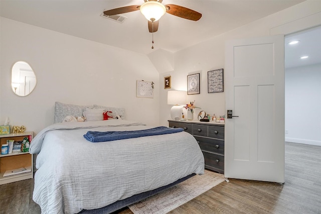 bedroom with baseboards, wood finished floors, visible vents, and ceiling fan