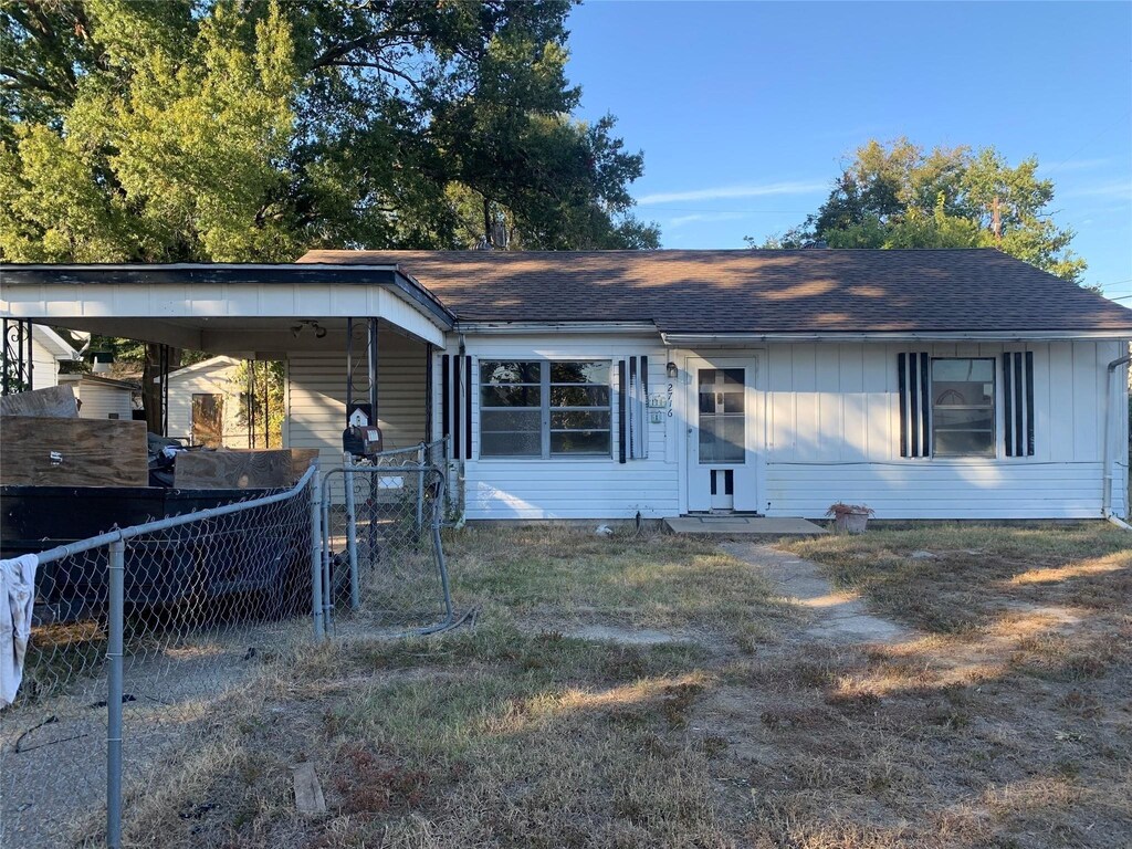 2716 Rosemont St, Shreveport, LA 71108 - view of front of house with an attached carport, roof with shingles, driveway, and fence