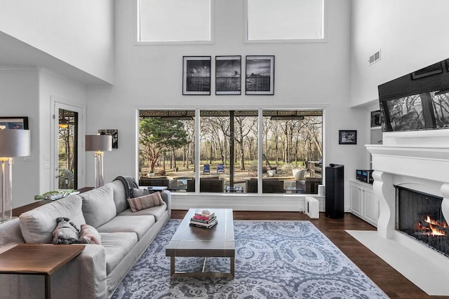 8604 Baltusrol Dr, Flower Mound, TX 75022 - living room with a towering ceiling, a fireplace with flush hearth, and dark wood-type flooring