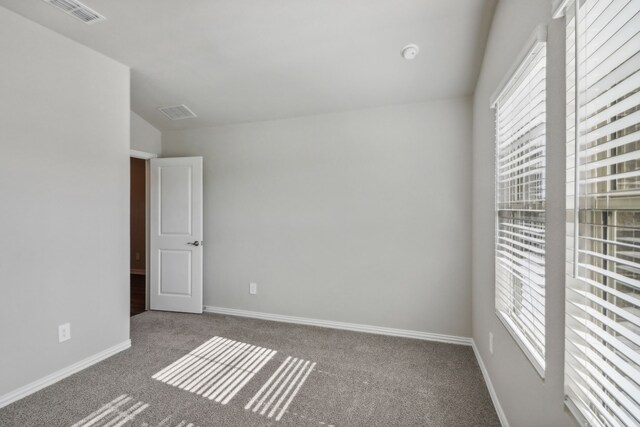 381 Sierra Rdg, Lavon, TX 75166 - empty room with carpet floors, plenty of natural light, baseboards, and vaulted ceiling