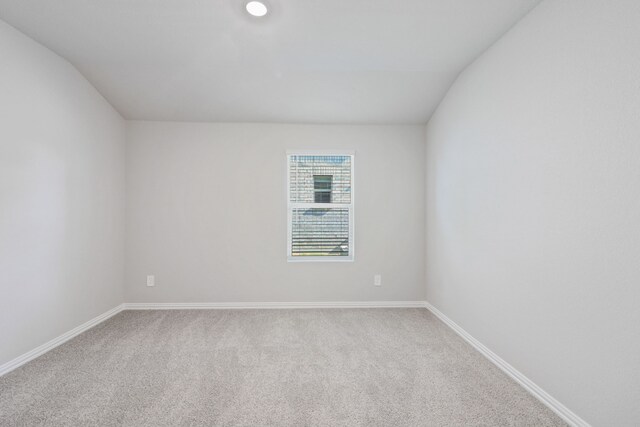 381 Sierra Rdg, Lavon, TX 75166 - carpeted spare room featuring baseboards and vaulted ceiling