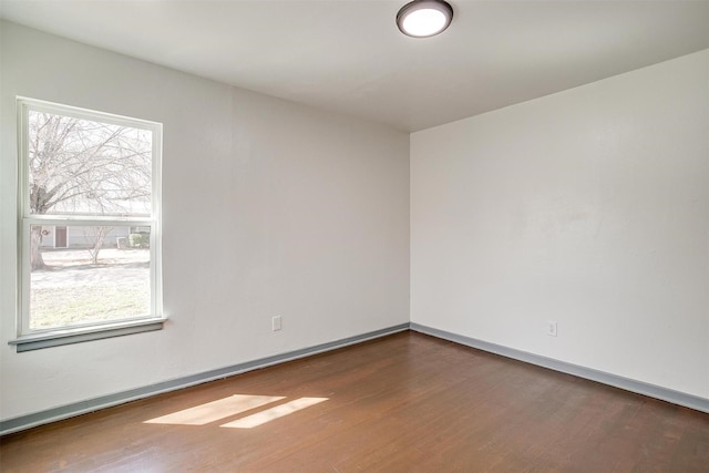 1036 Springer Ave, Fort Worth, TX 76114 - spare room featuring wood finished floors, healthy amount of natural light, and baseboards