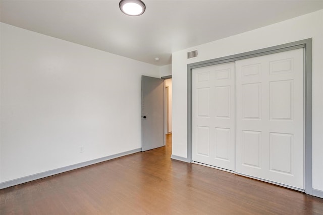 1036 Springer Ave, Fort Worth, TX 76114 - unfurnished bedroom with wood finished floors, a closet, and baseboards