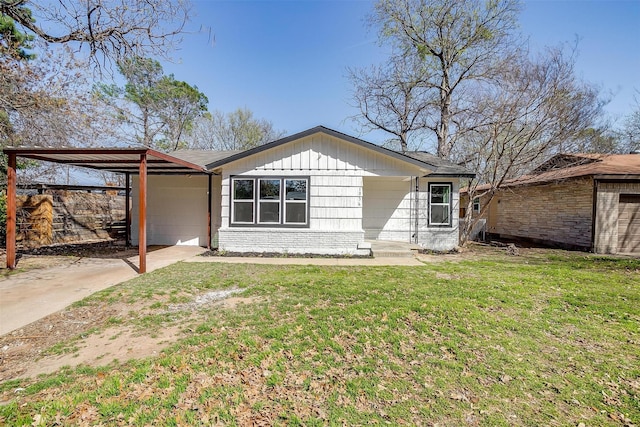 1036 Springer Ave, Fort Worth, TX 76114 - view of front of home featuring a front yard, an attached carport, brick siding, and driveway