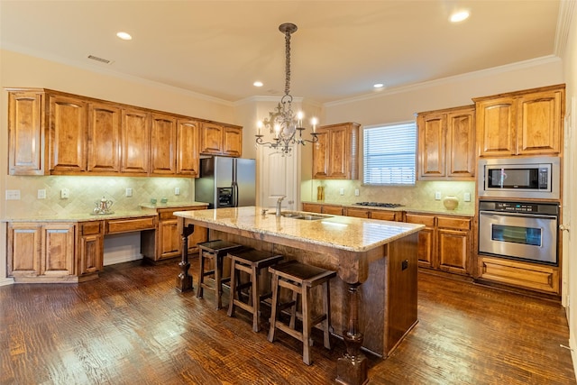 920 White River Dr, Allen, TX 75013 - kitchen with stainless steel appliances, a sink, brown cabinetry, light stone counters, and a kitchen bar