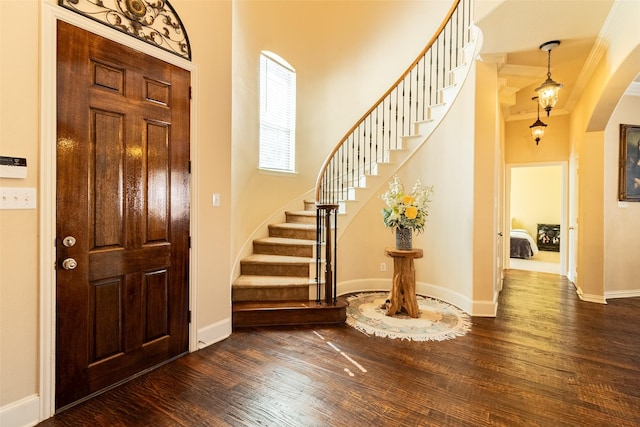 920 White River Dr, Allen, TX 75013 - foyer entrance with dark wood-type flooring, stairs, arched walkways, baseboards, and ornamental molding