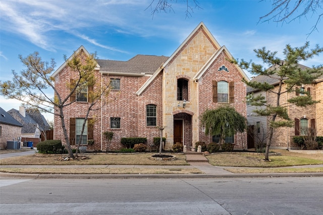 920 White River Dr, Allen, TX 75013 - view of front of property with cooling unit, brick siding, stone siding, and roof with shingles